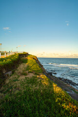 Colourful sunset over rocks at Susan Gilmore Beach, Newcastle, New South Wales Australia