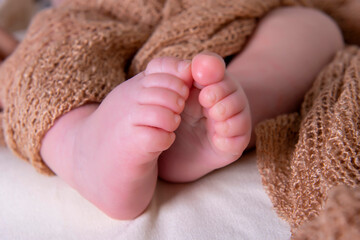 Baby feet on brown wrapped