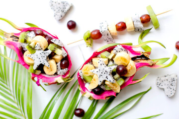 fresh exotick fruit dessert with varios colorful peace of fruits over white background