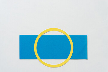 yellow paper ring isolated on a blue paper stripe