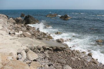 Fototapeta na wymiar Rocky seashore with big stones during the day