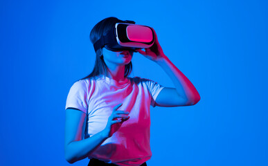 Creative engineer working with virtual reality, young woman testing VR glasses or goggles sitting...