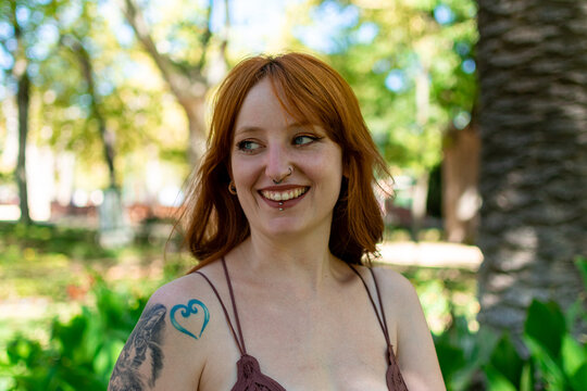 Young redhead woman smiling confident standing at park
