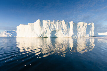 Climate change and global warming. Icebergs from a melting glacier in Greenland. The icy landscape...