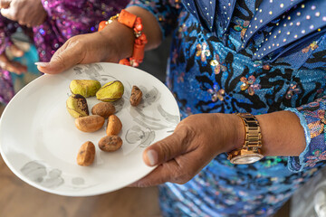 Serving Kola Nuts at a traditional Nigerian marriage Event