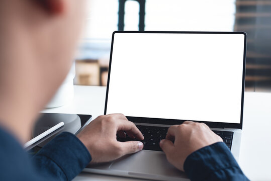 Mockup, Blank Screen Laptop Computer. Business Man Working On Laptop Computer On Table At Office. Mock Up For Website Design And Digital Marketing, Over Shoulder View