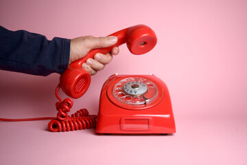 Why didn't you call? - classic rotary dial telephone being picked up by a hand
