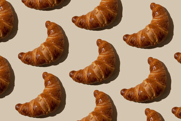 pattern of croissants on a light background. Baking concept