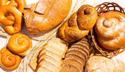 lot of different flavored bread, wheat, rye, on the table in the field outside