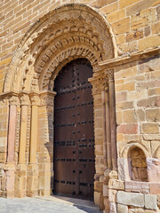 Fototapeta na wymiar Closeup of the north door of the church Santa Maria del Azogue, also called la Mayor, with columns and vegetal motifs decoration. Romanesque architecture. Benavente, Zamora, Castilla y Leon, Spain