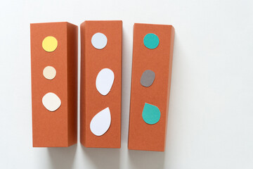 three isolated orange brown 3d paper objects with paper ornaments