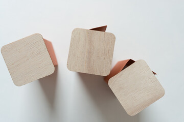 wood tiles with rounded corners balancing on brown paper objects