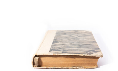 An old book with a yellowed cover. Old book isolated on a white background.