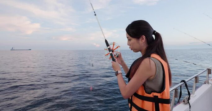 Woman Go Fishing On The Boat At Sunset Time