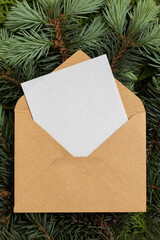 White empty greeting card in an envelope. Christmas background.