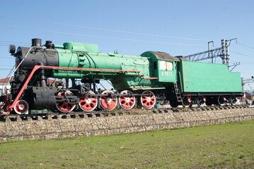 Fototapeta na wymiar Monument to a steam locomotive near the railway station in the city of Petushki, Vladimir region