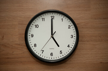 office wall clock indicating the five o clock hour