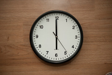 office wall clock indicating the six o clock hour