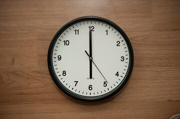 office wall clock indicating the six o clock hour