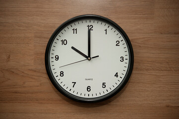 office wall clock indicating the ten o clock hour