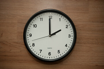 office wall clock indicating the two o clock hour