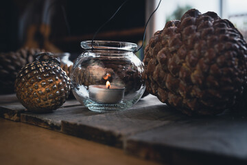 Sustainable elegant christmas decoration on dark wooden table with pine cone, candle light and...