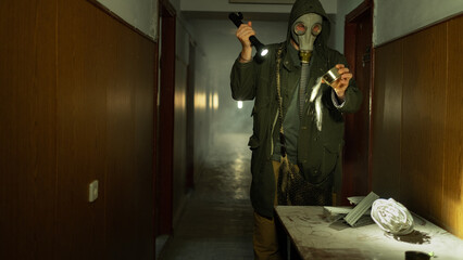 Stalker, in radioactive zone, post apocalyptic. Man in gas mask search food. Pollution of...