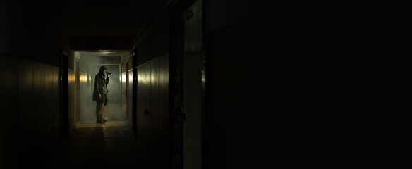 Brave post apocalyptic survivor with gas mask and flashlight. environmental disaster, crime and...