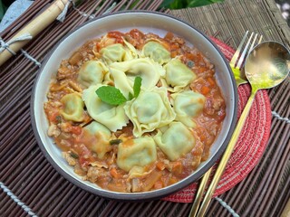 Ravioli stuffed with chopped spinach Parmesan Cheese and Ricotta Cheese with Stir Fried Pork with Sour Sauce