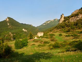 house surrounded by mountains and green meadows