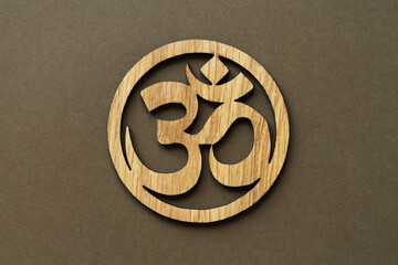 Wooden om or aum symbol of hinduism and buddhism - obrazy, fototapety, plakaty