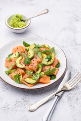 Salmon salad with avocado,  for keto and low carb diet. Rusty background, top view, copy space.