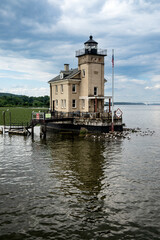Fototapeta na wymiar Kingston, NY – USA – Aug 2, 2022 Horizontal view of the historic Rondout Light, a lighthouse consisting of a square tower and attached to a rectangular, two-story dwelling. Built on the Hudson River.