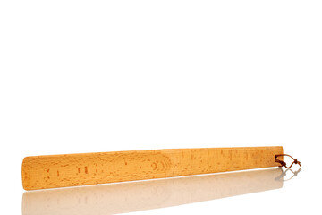 One wooden shoehorn, macro, isolated on white background.