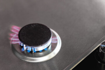 50% Fifty percent gas savings in the European Union EU gas stove burner due to sanctions. Red and blue fire, top view, copy space.