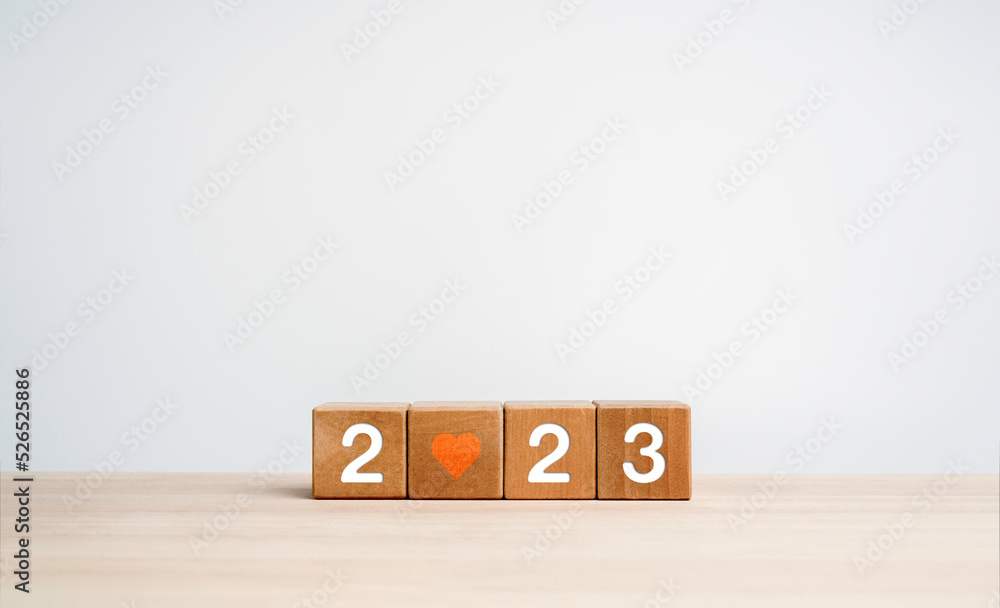 Poster 2023 happy new year background banner. two thousand twenty-three year numbers with red heart on wood