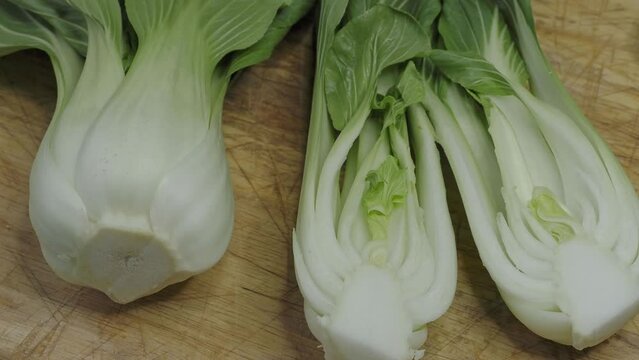 Endives on a wooden cutting board (Cichorium intybus). Fresh chicories
