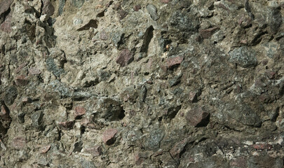 abstract grunge background: rough wall of granite stones and concrete