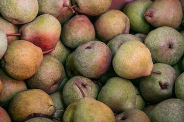 Ripe fresh pears. Beautiful pears. Background from pears. Close-up. Sale of pears at the farmers' market.