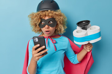 Shocked curly haired superhero checks notification on smartphone gets order of service cleaning...