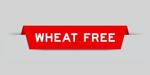 Red color inserted label with word wheat free on gray background