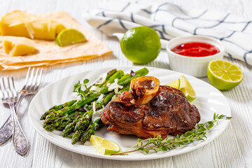braised osso buco with grilled asparagus, top view
