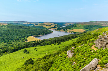 A view down the slopes on Bamford Edge towards Ladybower reservoir, UK in summertime