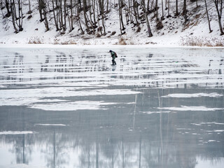 Dangerous exit to the spring thin ice. A man walks on thin ice. Forbidden access to the ice in the...