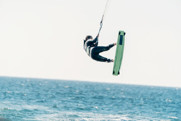 young latino in the air doing kitesurfing