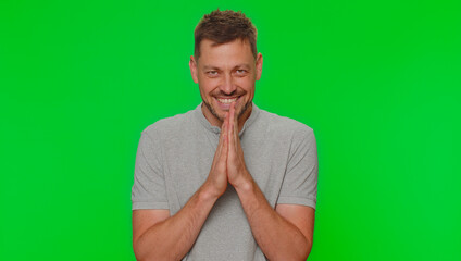 Sneaky cunning handsome man with tricky face gesticulating and scheming evil plan, thinking over devious villain idea, cunning cheats, jokes and pranks. Adult guy on green chroma key studio background
