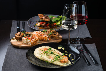 Top view of various Italian dishes with red and white wine