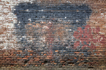 A grungy brick wall with layers of paint.