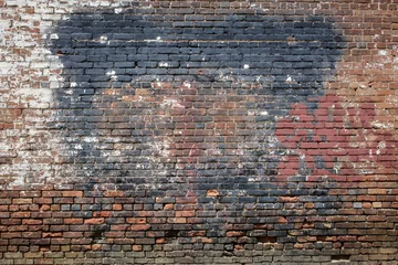 Papier Peint photo Graffiti A grungy brick wall with layers of paint.