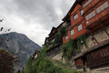 Fototapeta na wymiar Architecture of the town of Hallstatt in Austria. Wooden houses built on rocks. Access stairs.
